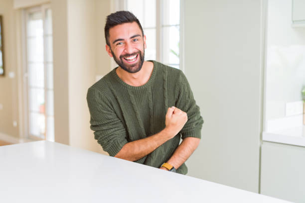 istock Handsome man celebrating and cheering with excitement expression, smilling for winning success 1167773011
