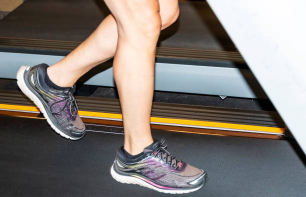 istock Legs running on a treadmill indoors 1167773335