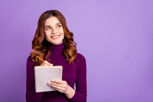 Portrait of charming college people holding hand pencil having thoughts isolated over purple violet background Portrait of charming college, people holding hand pencil having thoughts isolated over purple violet background turtleneck photos stock pictures, royalty-free photos & images