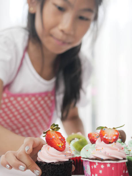 istock Girl with homemade cupcake on table, selective focus, lifestyle concept. 1167775554
