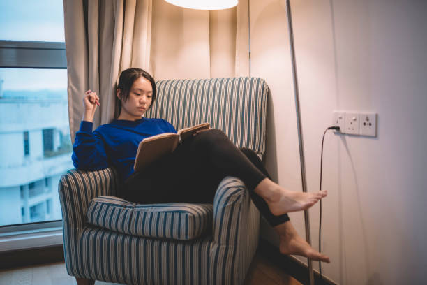 istock a young asian chinese female student sitting on sofa studying holding pen and note book preparing her exam 1167775717