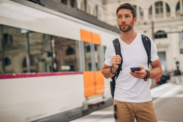 istock Man waiting for train at station 1167777104