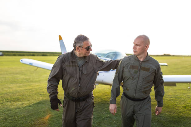 istock Flight crew after flight walking on meadow at airport 1167777447