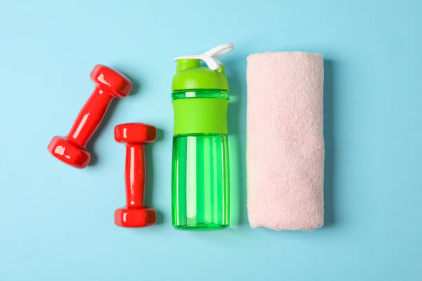 istock Flat lay composition with towel, dumbbells and fitness bottle on blue background 1167777721