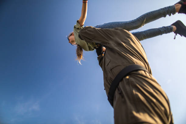 istock Low angle view of  father holding daughter high over head 1167777751