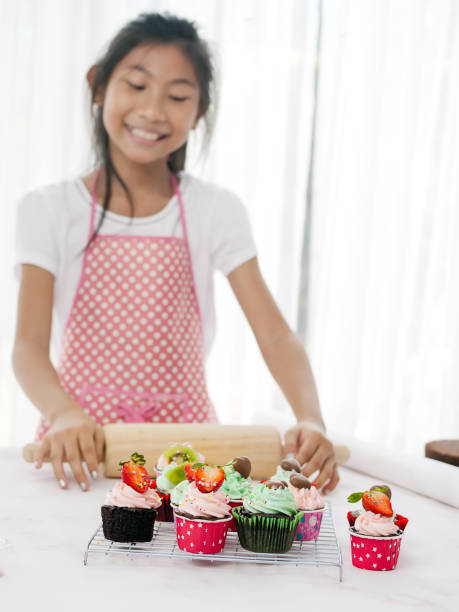 istock Girl with homemade cupcake on table, selective focus, lifestyle concept. 1167778467