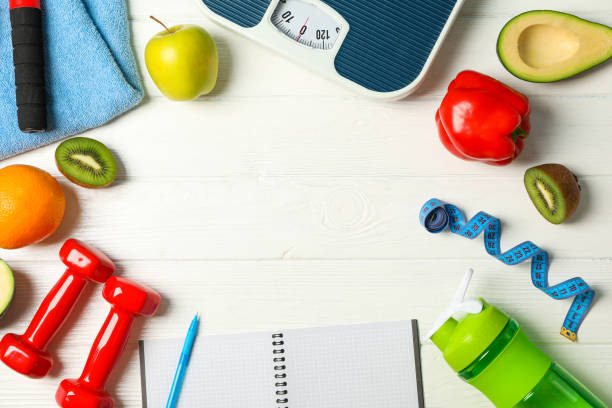 istock Flat lay composition with loss weigh accessories on white wooden background 1167780825