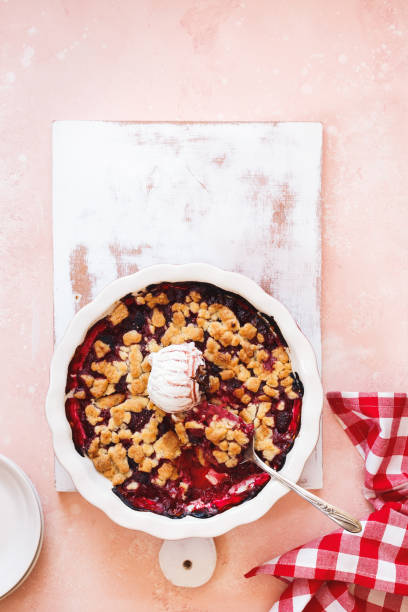 istock Berry crumble in baking dish with vanilla ice cream and spoon 1167784331