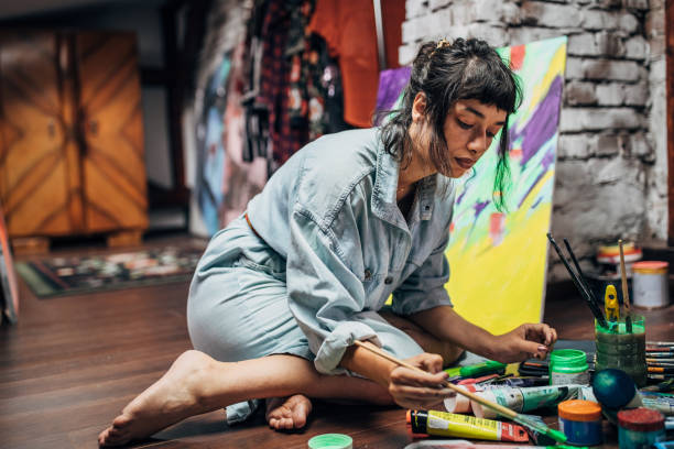 istock Beautiful female artist working in her studio 1167784821