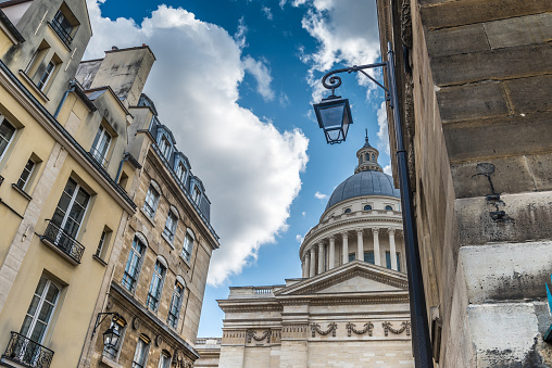 View of the dome of The Panthéon monument surrounded by classic buildings of the Latin Quarter of Paris. Located in the 5th arrondissement on the Montagne Sainte-Geneviève, the Panthéon looks out over all of Paris.