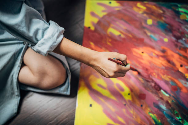 istock Creative woman painting in her studio 1167785217