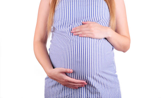 istock A cute pregnant belly isolated on a white background 1167787342