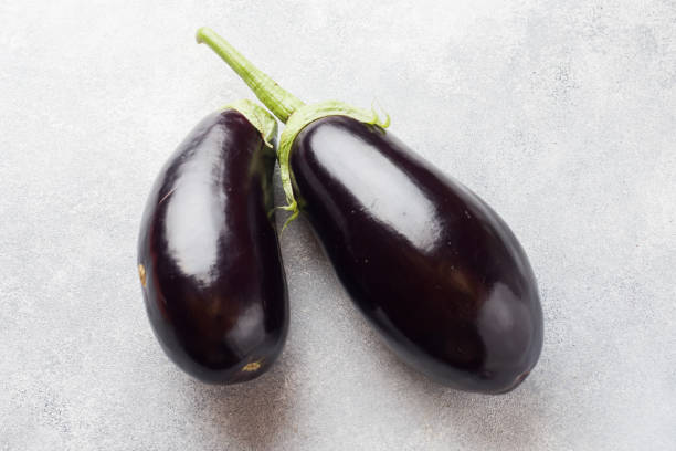 istock Fresh eggplant on grey concrete background with copy space. 1167787507