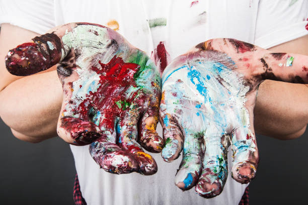 istock A painter's hand is covered with paintDrawing paint 1167788786
