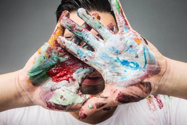 istock A painter's hand is covered with paintDrawing paint 1167789767