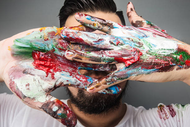 istock A painter's hand is covered with paintDrawing paint 1167789779