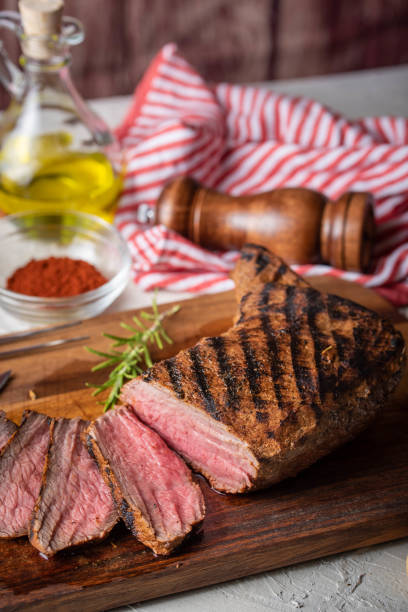 sliced tri tip seak marinated with santa maria sauce  on wooden cutting board sliced tri tip seak marinated with santa maria sauce  on wooden cutting board santa maria california photos stock pictures, royalty-free photos & images