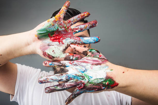 istock A painter's hand is covered with paintDrawing paint 1167790055