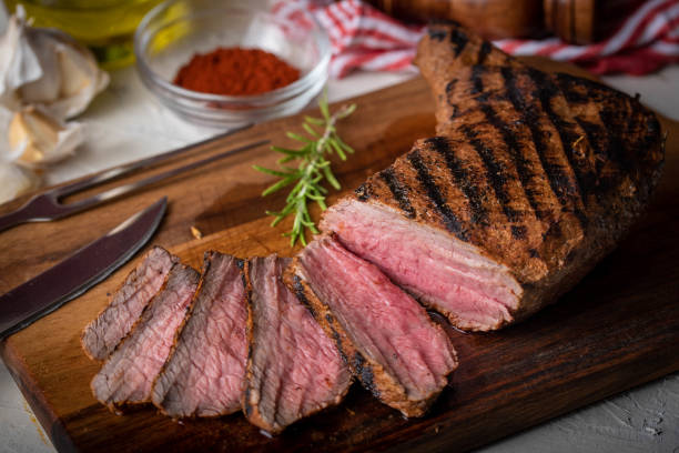 sliced tri tip seak marinated with santa maria sauce  on wooden cutting board sliced tri tip seak marinated with santa maria sauce  on wooden cutting board santa maria california photos stock pictures, royalty-free photos & images