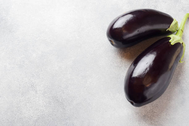 istock Fresh eggplant on grey concrete background with copy space. 1167790246