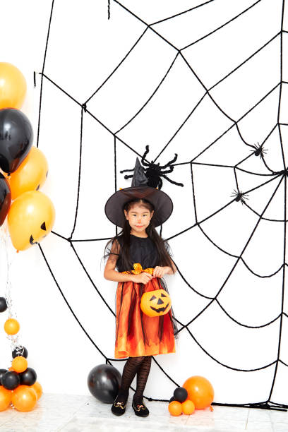 istock Asian children in witch dressed costume and pumpkin figure on white background 1167791049