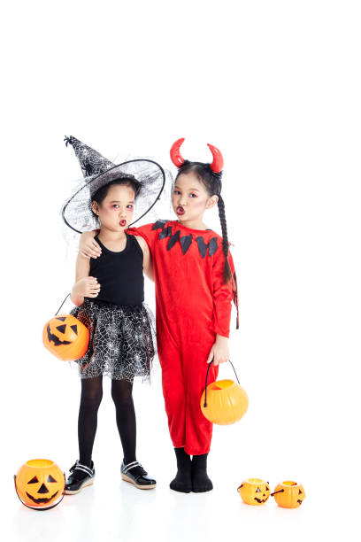 two little asian girl with face-paint in devil halloween and witch dress costume white background - 2839 imagens e fotografias de stock