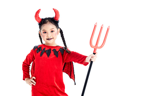 Young female adult looking into the camera wearing a devil costume. She is wearing spectacles and smiling with her teeth.