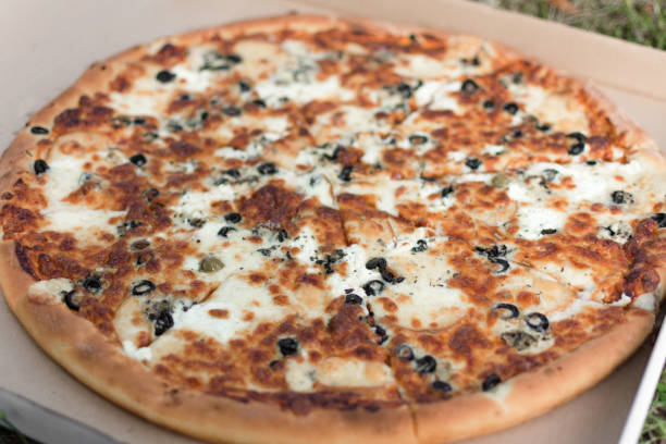 istock Pizza in a cardboard box top view. 1167792550