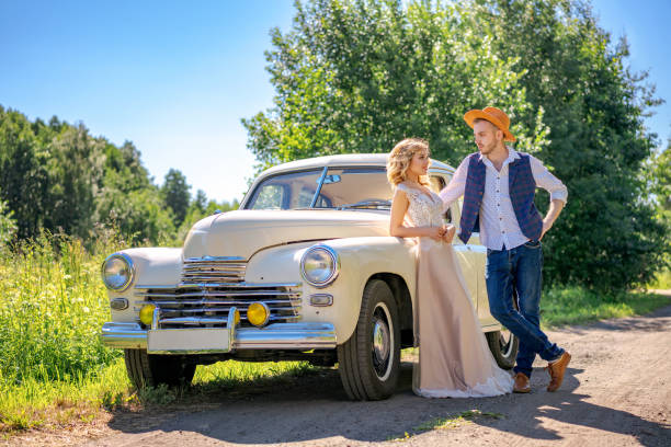 istock beautiful young couple standing by the car 1167792903