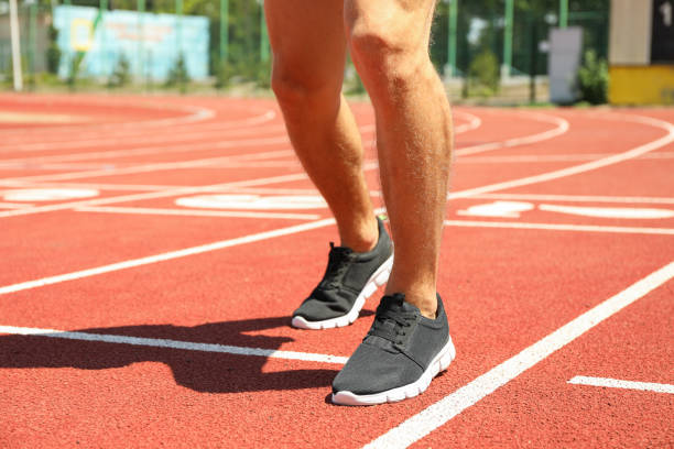 istock Man in sneakers on red athletic running track, close up 1167793302