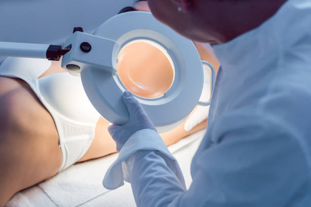 istock Therapist using loupe during hair removal procedure 1167793457