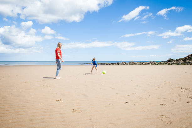 istock Mother and Son Playing Soccer on the Beach 1167798301