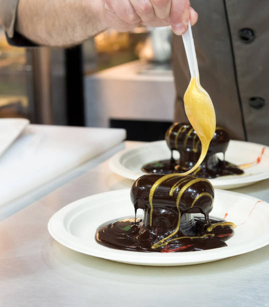 istock Pastry chef decorating, chef preparing desert chocolate cake 1167798873