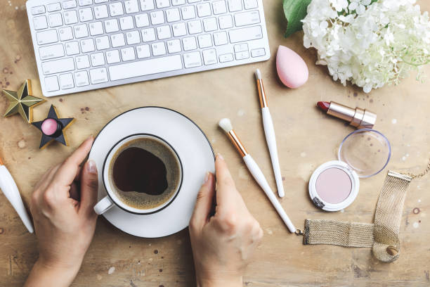 istock Women's blog concept. Office table with flowers, make up brush and cosmetics. 1167799721