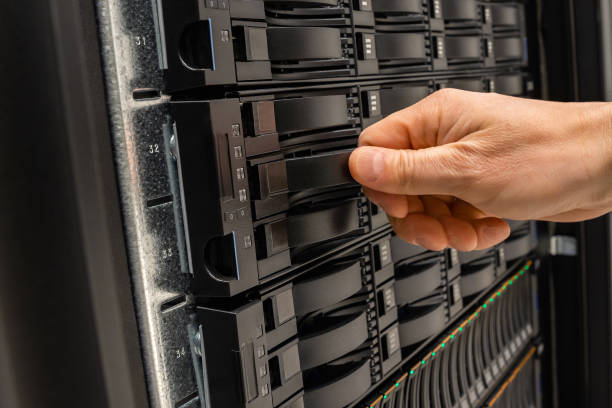istock Male IT Engineer Replacing Server Drive in SAN At Datacenter 1167799819