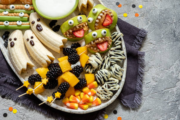 Healthy Fruit Halloween Treats. Healthy Fruit Halloween Treats. Banana Ghosts, Clementine Orange Pumpkins and Apple Monster Mounts halloween treats stock pictures, royalty-free photos & images