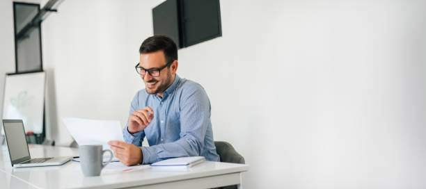 istock Young smiling cheerful confident businessman checking working plan and schedule or timetable in office copy space 1167802781