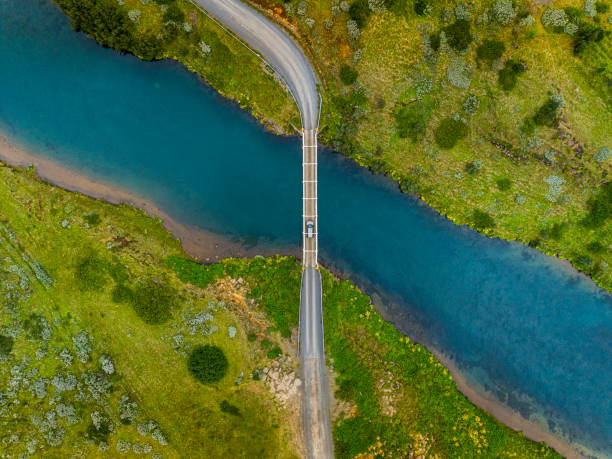 istock Car driving over bridge with stream of water going under. 1167803867
