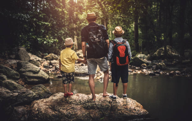 istock Father with sons exploring river in a tropical forest 1167804754