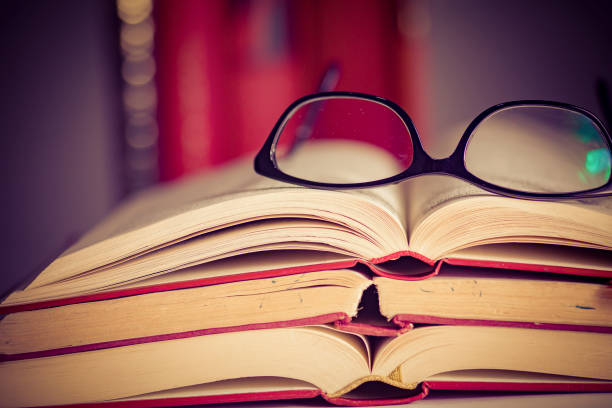 istock Glasses lies on red books 1167807641
