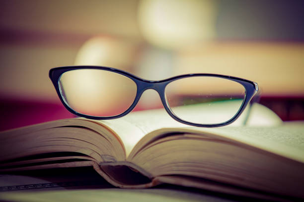 istock Glasses lies on red books 1167807653