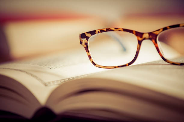 istock Glasses lies on red books 1167807674