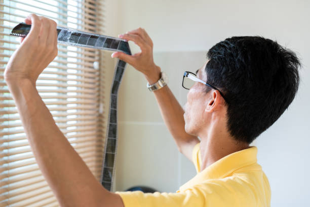 istock Man inspecting a film after developed. 1167807827