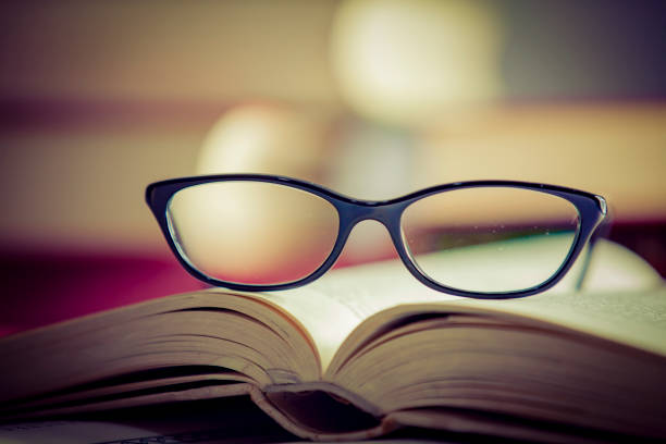 istock Glasses lies on red books 1167807862