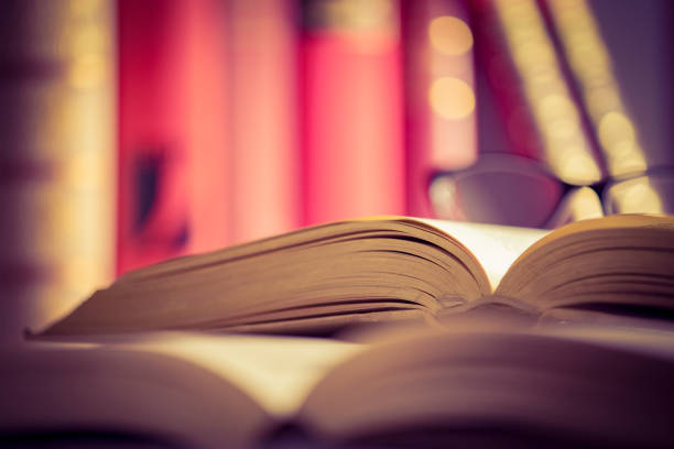 istock Glasses lies on red books 1167808072