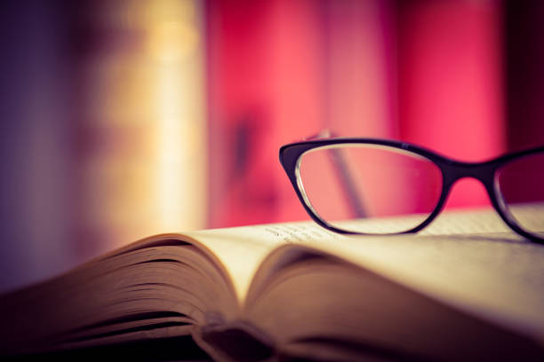 istock Glasses lies on red books 1167808952