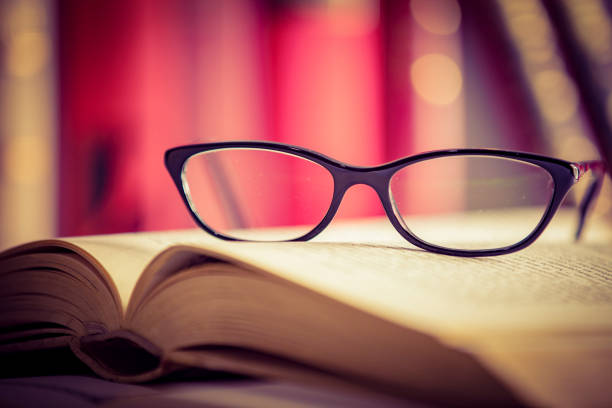 istock Glasses lies on red books 1167808988