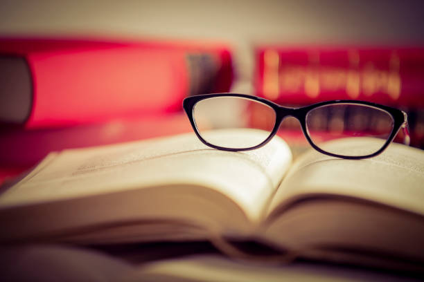 istock Glasses lies on red books 1167809023