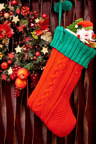 istock Christmas stocking and decorated wreath close-up. 1167809348