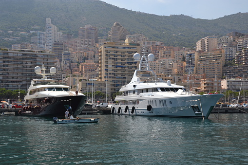 Monte Carlo, Monaco - 1st August, 2014: Super-luxury yachts in a harbor. These yachts are available for charter.